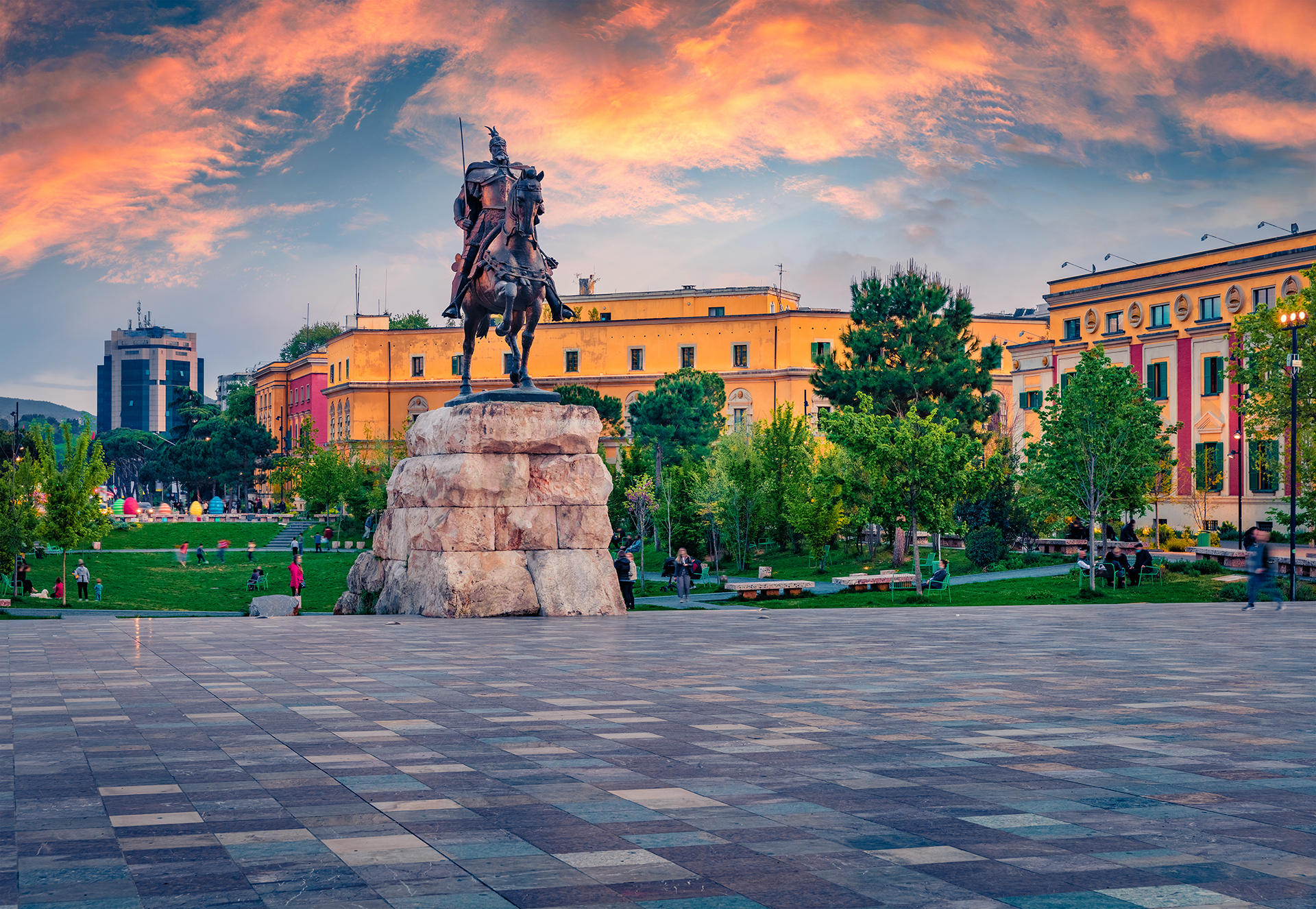 Equestrian statue in a city square surrounded by historic buildings and gardens at sunset, featured on a 7-day UNESCO-protected sites itinerary.